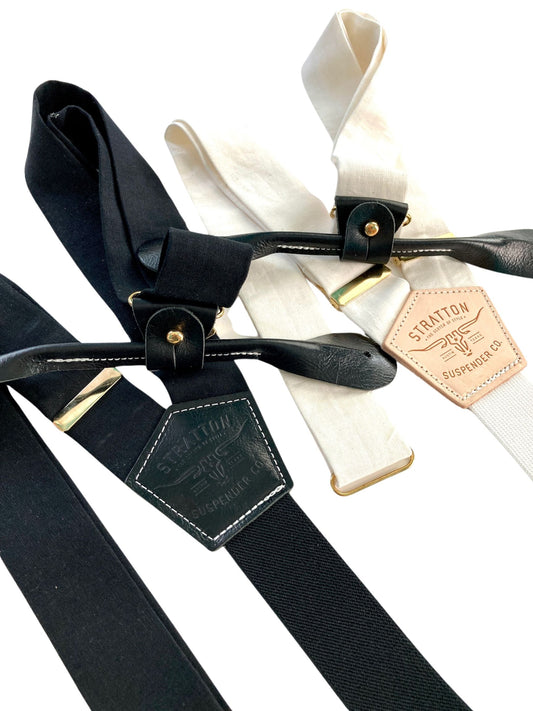 Handmade black and ivory linen button-on suspenders with full-grain veg-tan leather, gold-colored solid brass hardware, and premium soft twill elastic. Ethically made in Texas, perfect for formal wear, weddings, and black-tie events. Timeless, heritage-inspired style.