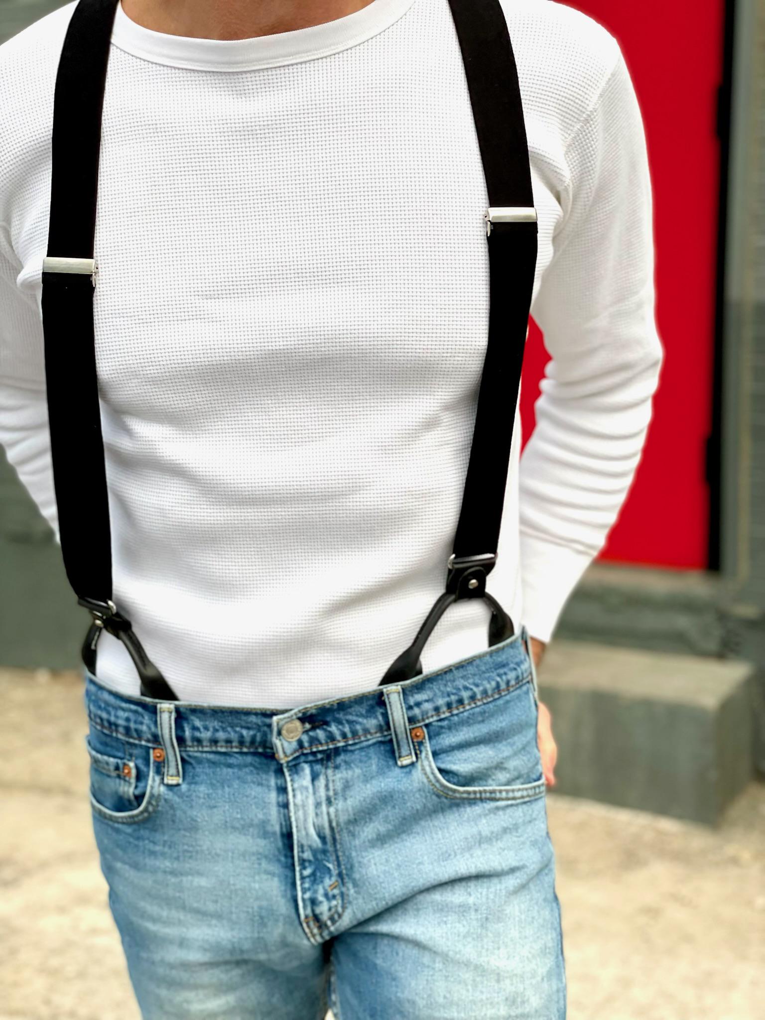 Close-up of Classic Black Linen Suspenders with Black Leather Button-On Attachments, styled with a white waffle knit Henley and vintage denim. Perfect for heritage menswear, wedding attire, modern western style, and timeless everyday fashion.