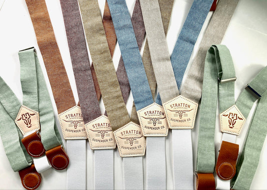 Custom wedding order featuring pistachio green suspenders for children and women, along with burnt orange, maroon rust, taupe, pastel blue, and beige groomsmen suspenders. Handmade with woven linen straps, premium veg-tan leather button attachments, and soft elastic back straps for a refined and timeless look. Perfect for rustic weddings, boho wedding themes, and heritage menswear styling.