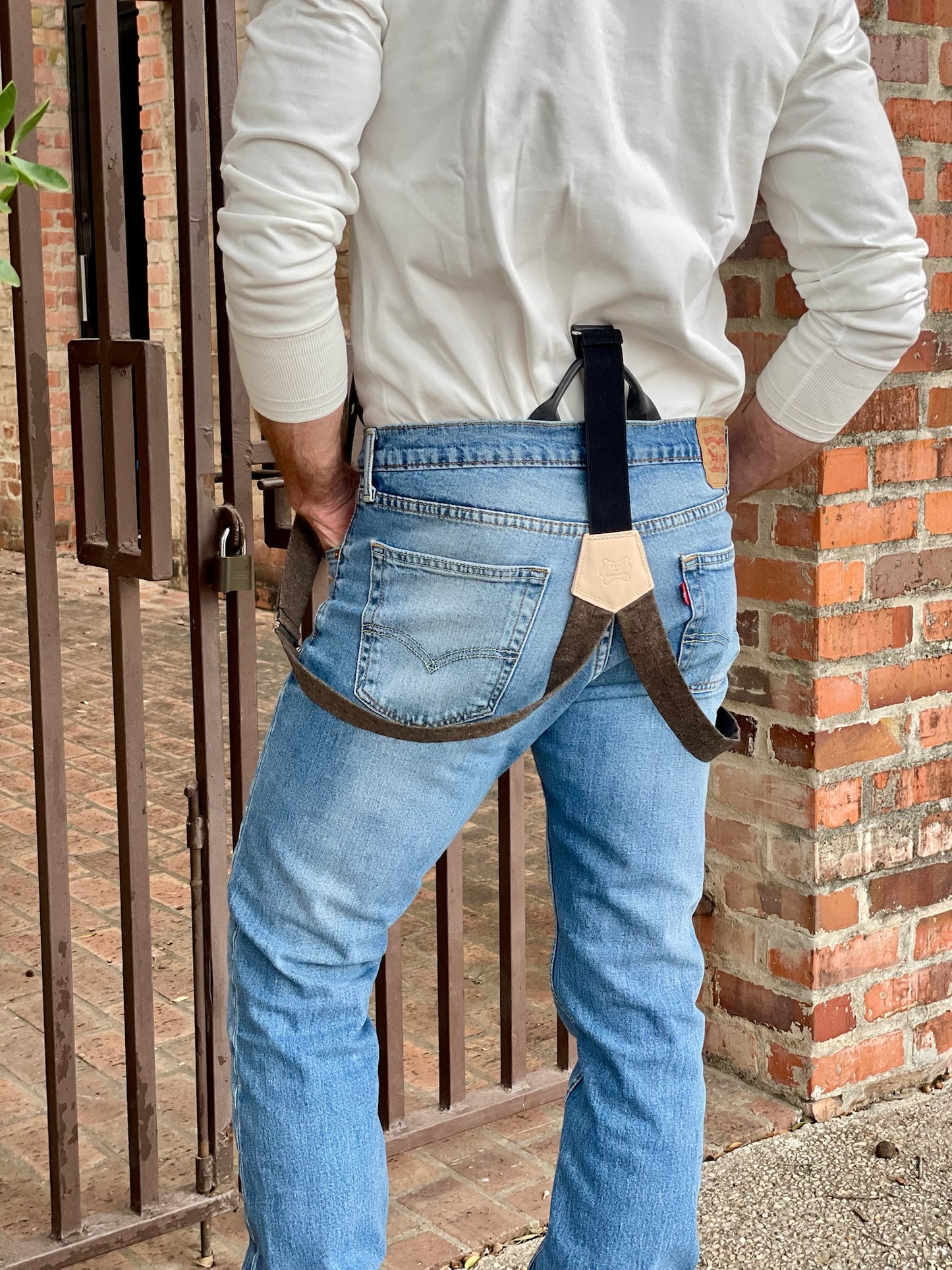 Back view of Espresso Brown Linen Button-On Suspenders with Black Leather Attachments, featuring a handcrafted veg-tan leather back patch, styled with classic denim and a vintage white Henley – Handmade by Stratton Suspender Co. for a heritage menswear look.