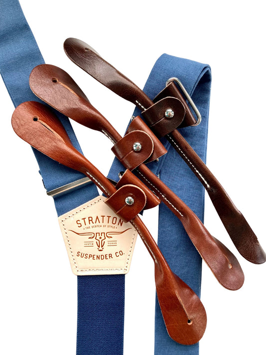 French blue linen suspenders with navy back strap and premium leather button attachments in tan, chocolate, and black, handmade in the USA by Stratton Suspender Co., ideal for groomsmen and vintage wedding attire.
