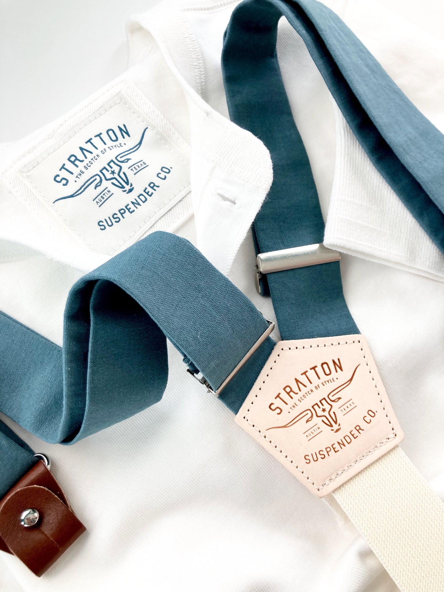 Teal blue linen button-on suspenders with a cream back strap, handcrafted for weddings, groomsmen, and vintage menswear. Premium leather attachments and timeless design for formal and rustic weddings.