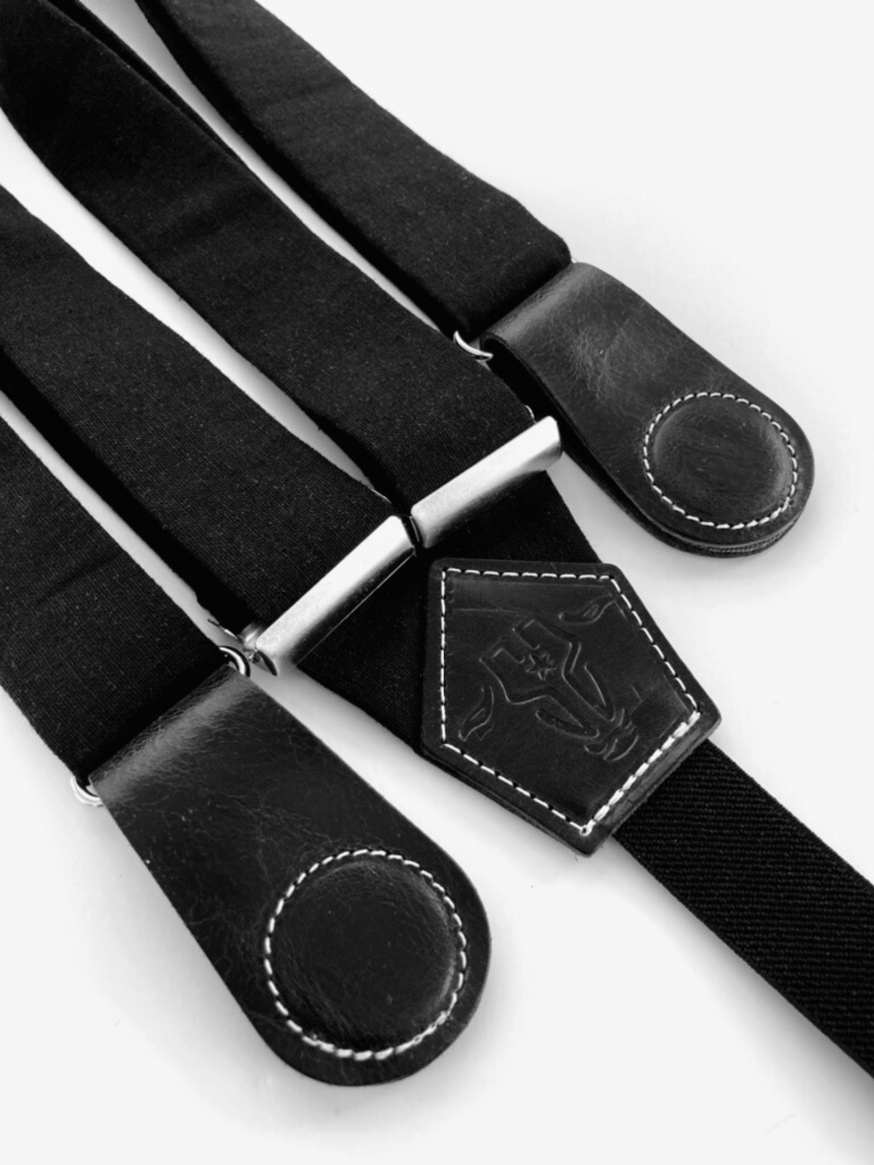 Close-up of black women’s suspenders with full-grain leather magnetic clasps – handmade in Texas