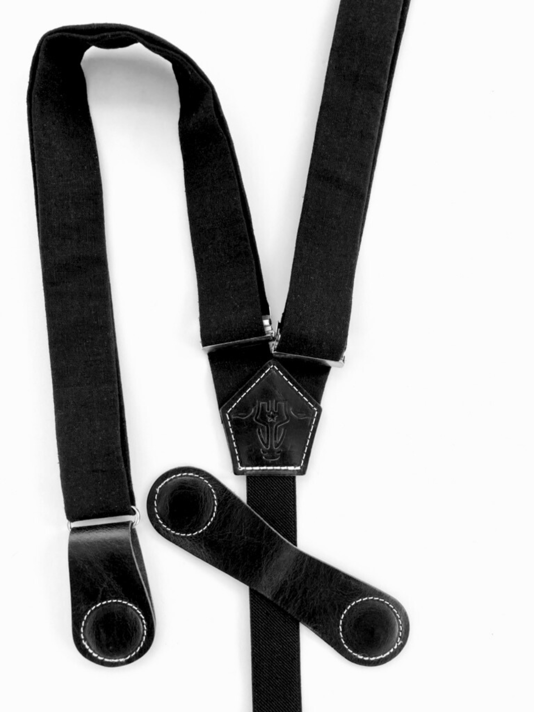 Black women’s suspenders with magnetic leather clasp partially open to show closure design – handmade in Texas