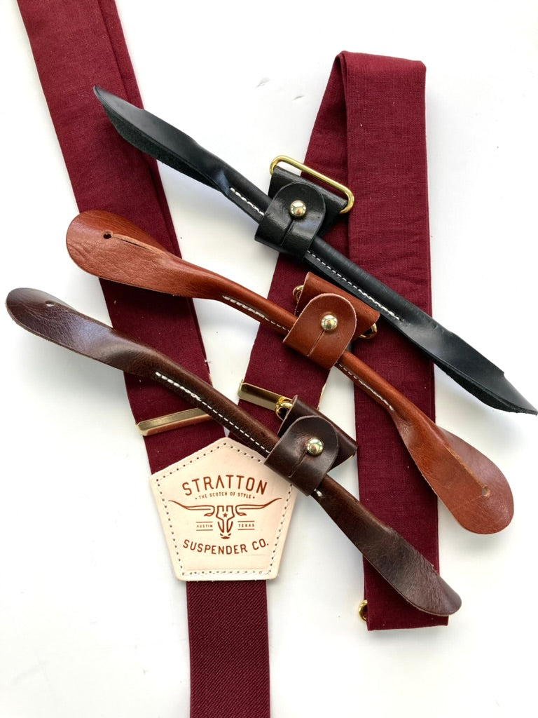 Bordeaux linen wedding suspenders with gold hardware shown with four leather button-on tab options: black, chocolate, cognac, and tan.