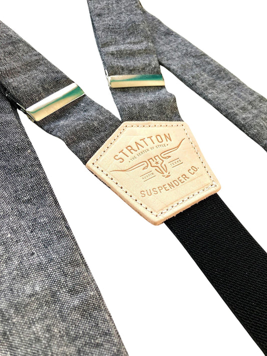 Close-up of charcoal linen suspenders with natural leather back patch and silver-tone adjusters, handmade in Texas by Stratton Suspender Co.—ideal for rustic weddings and timeless men's fashion.