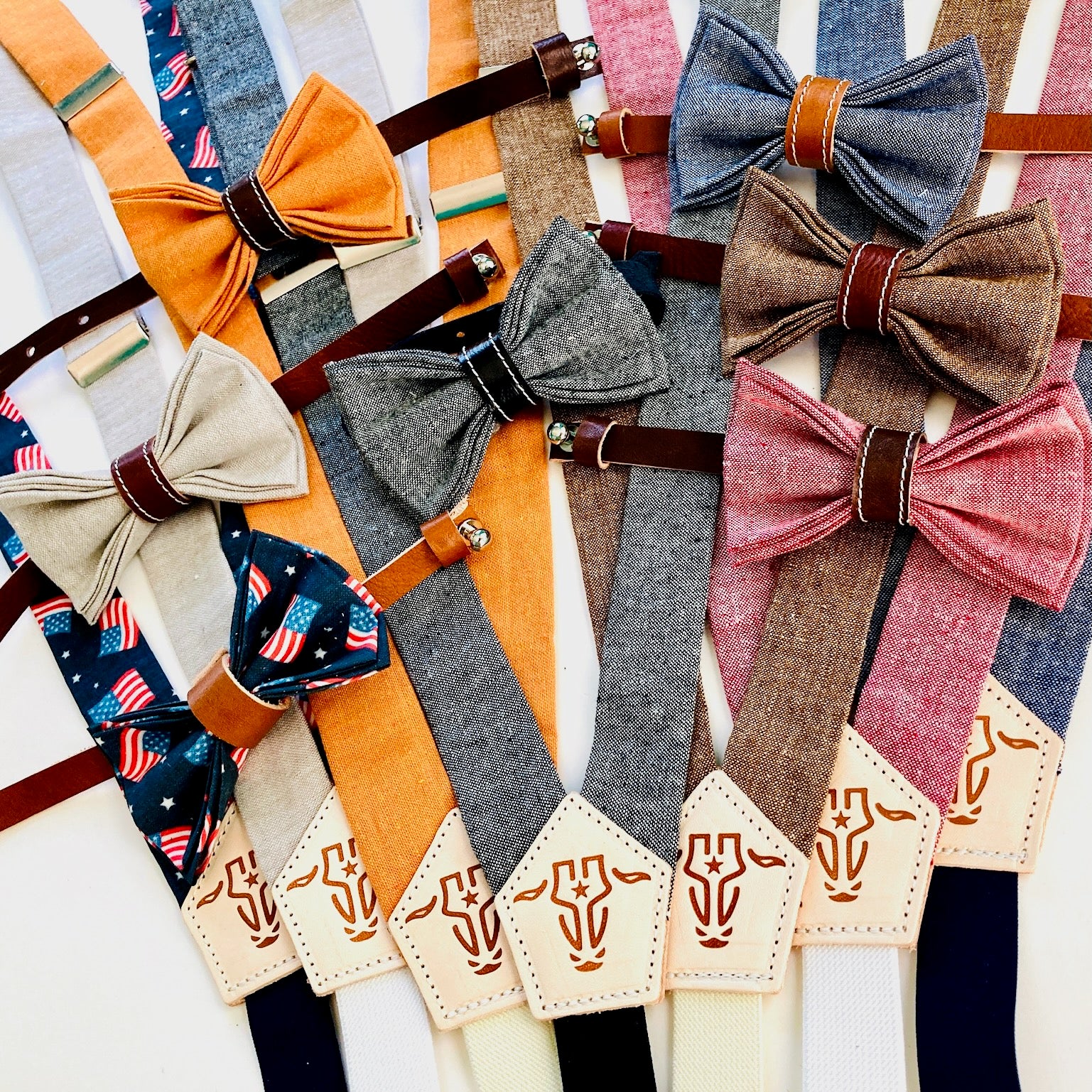 Children’s suspenders and pre-tied bow tie collection in assorted colors, handmade from linen with leather accents and magnetic clasps.