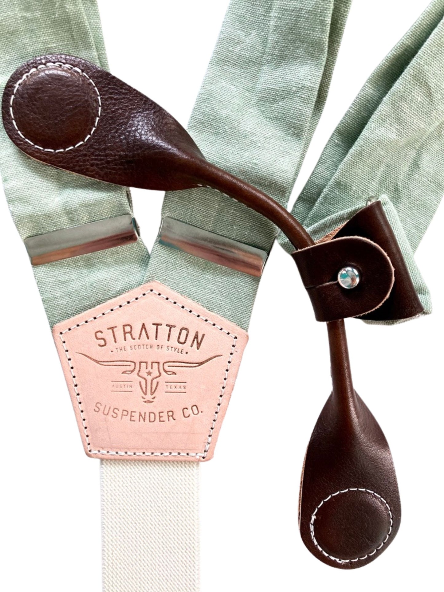 Chocolate brown magnetic leather clasp shown over pistachio green linen suspenders—ideal for rustic weddings and formal menswear.
