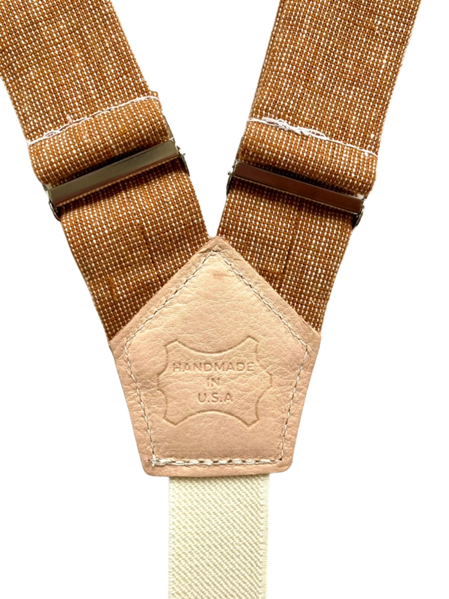 Close-up of Cinnamon Pecan women’s linen suspenders with leather back patch stamped Handmade in USA, highlighting craftsmanship.