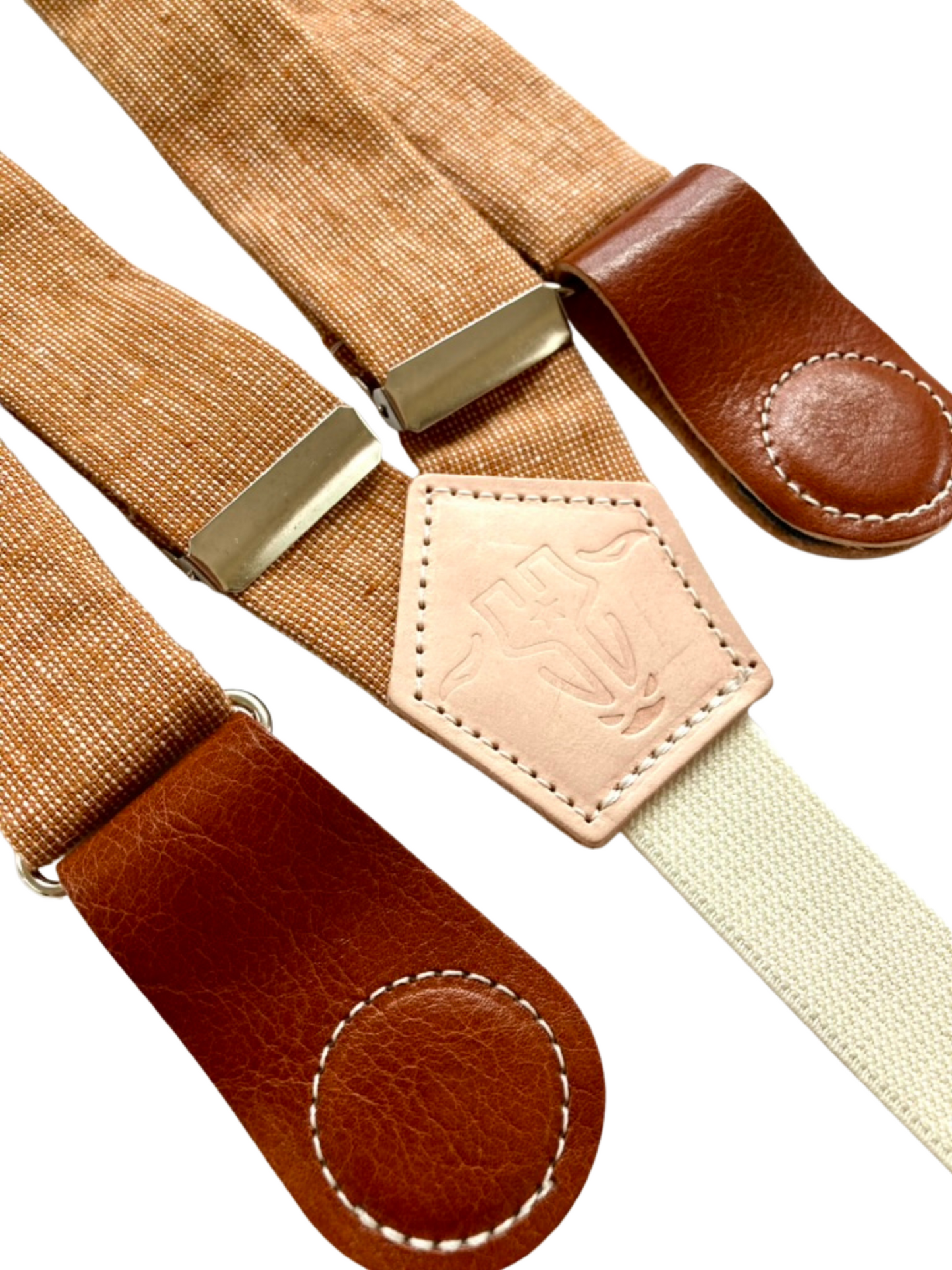Close-up of Cinnamon Pecan women’s suspenders, vintage hand-woven linen straps with Cognac leather magnetic clasps, handmade in Texas.