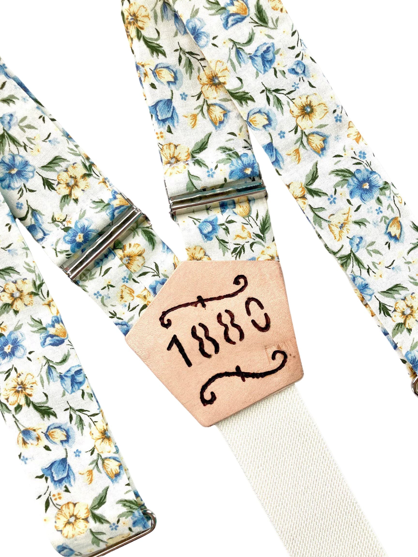 Cornflower blue and marigold floral wedding suspenders with personalized '1880' engraved leather patch, handmade by Stratton Suspender Co.