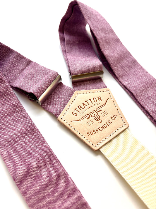 Purple suspenders with a leather strap displaying 'Stratton Suspenders Co.' on a white background