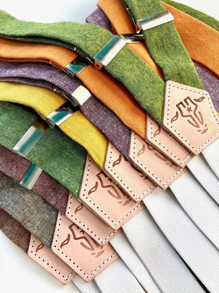 Bold fall women’s suspenders collection featuring linen straps in seasonal colors, including rust maroon and earthy tones.