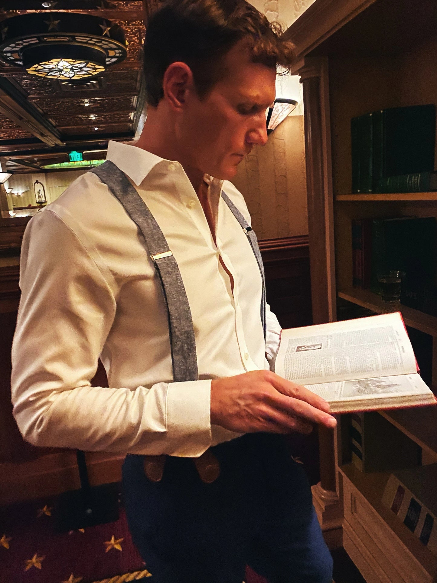 Formal blue suspenders with tan magnetic clasps styled with dress shirt and slacks at the Driskill Hotel in downtown Austin.