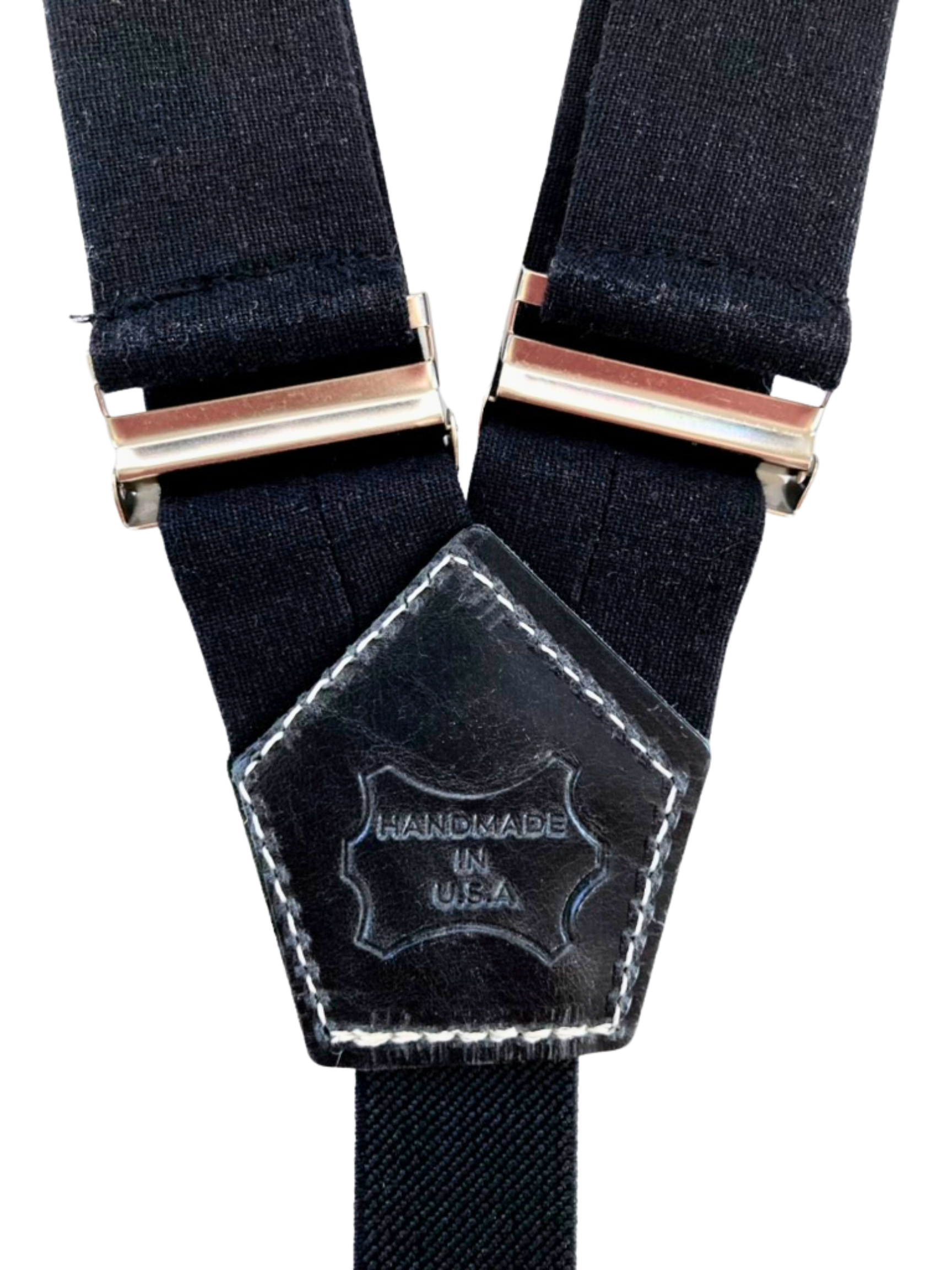 Close-up of Handmade in USA leather stamp on black women’s suspenders – full-grain leather detail