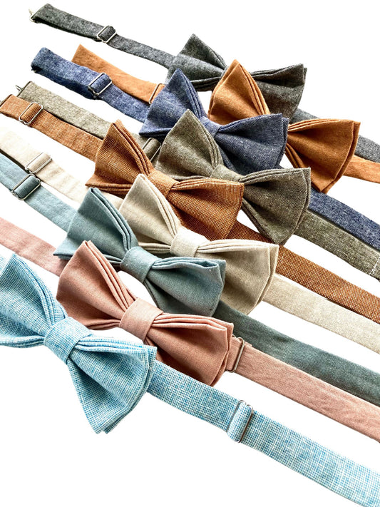 A collection of pre-tied linen bow ties with polished brass clasps in powder blue, dusty rose, dusty blue, beige, roasted pecan, olive, black, and burnt orange—perfect for groomsmen, wedding parties, formal events, and stylish workwear.