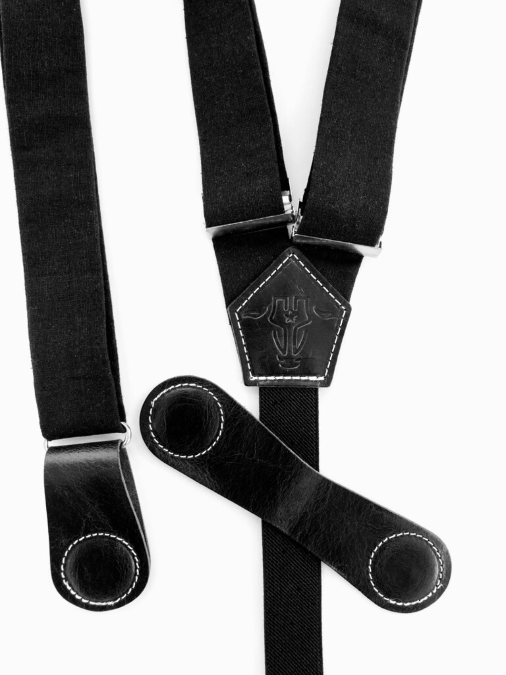 Close-up of magnetic clasp system on black women's suspenders with full-grain leather and contrast stitching