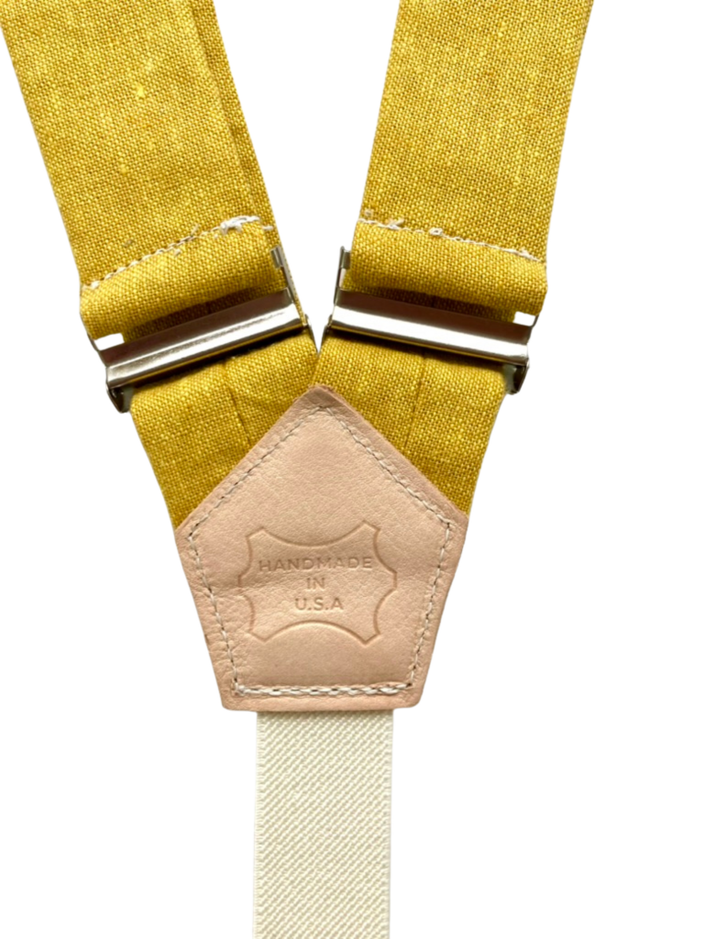 Mustard yellow linen suspenders with leather back patch stamped Handmade in U.S.A., handcrafted in Texas.