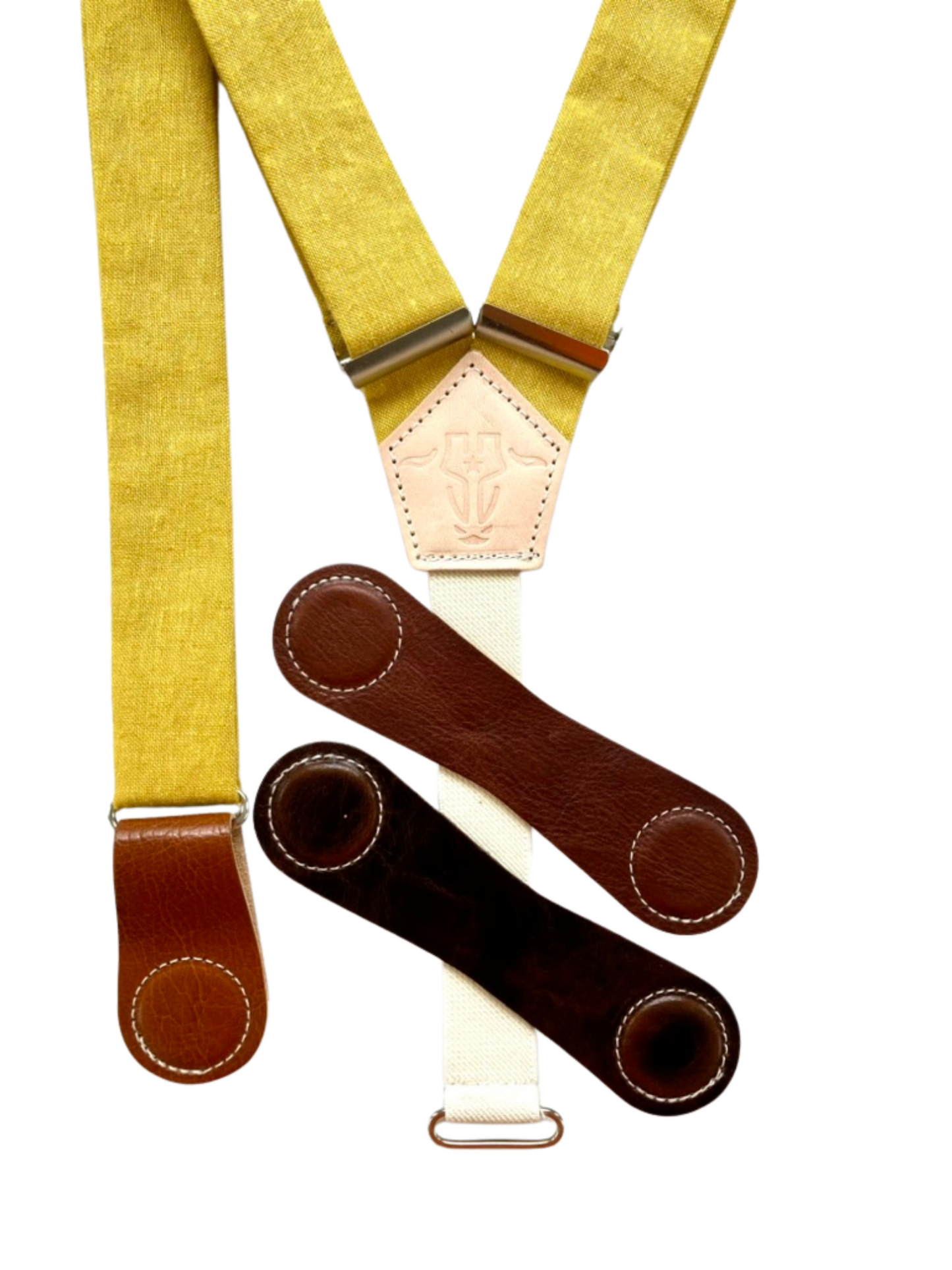 Mustard yellow women’s linen suspenders with interchangeable leather magnetic clasps in tan, chocolate, and cognac.