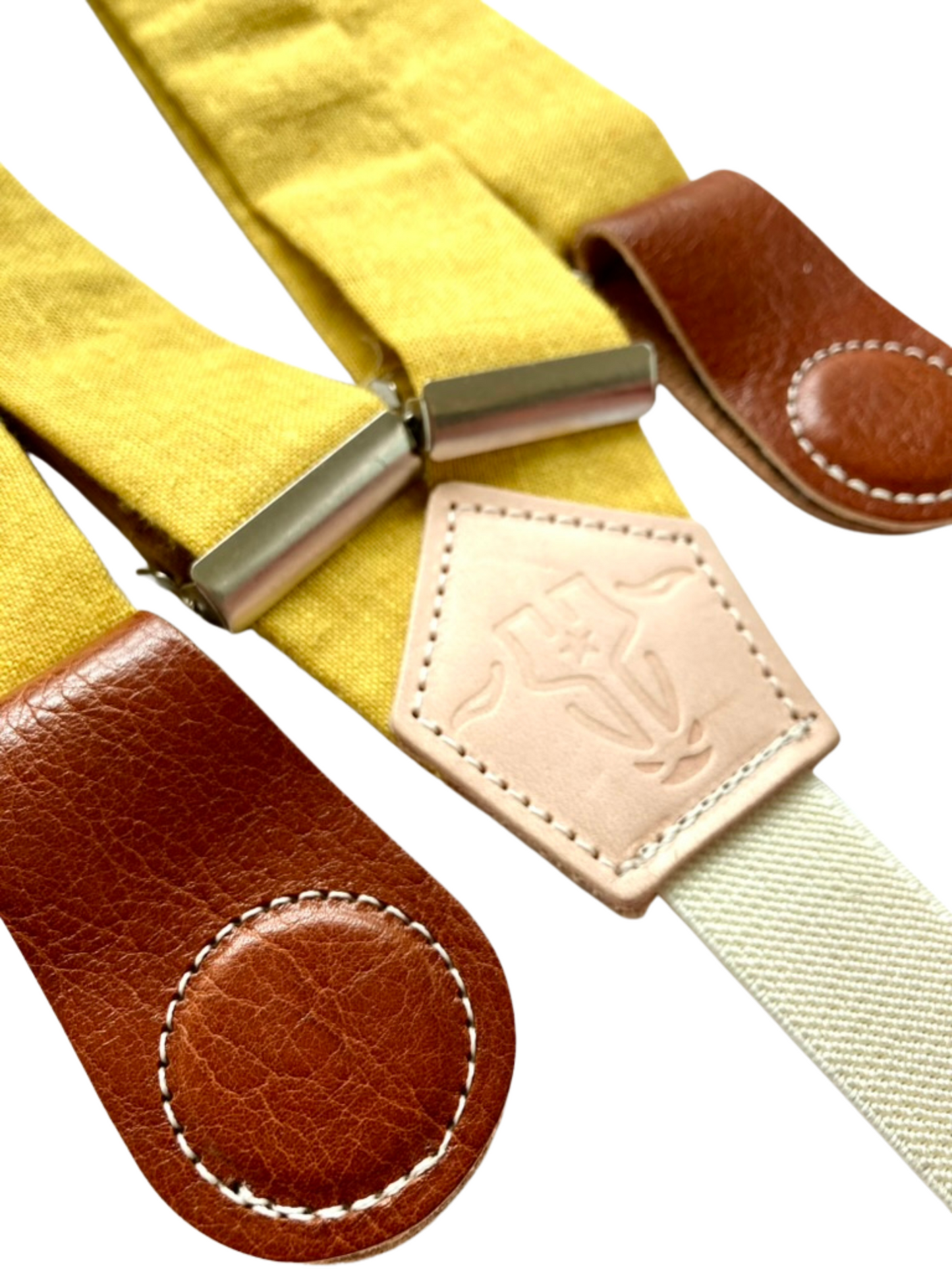 Mustard yellow women’s linen suspenders with tan leather magnetic clasps, handcrafted in Texas for vintage-inspired outfits.