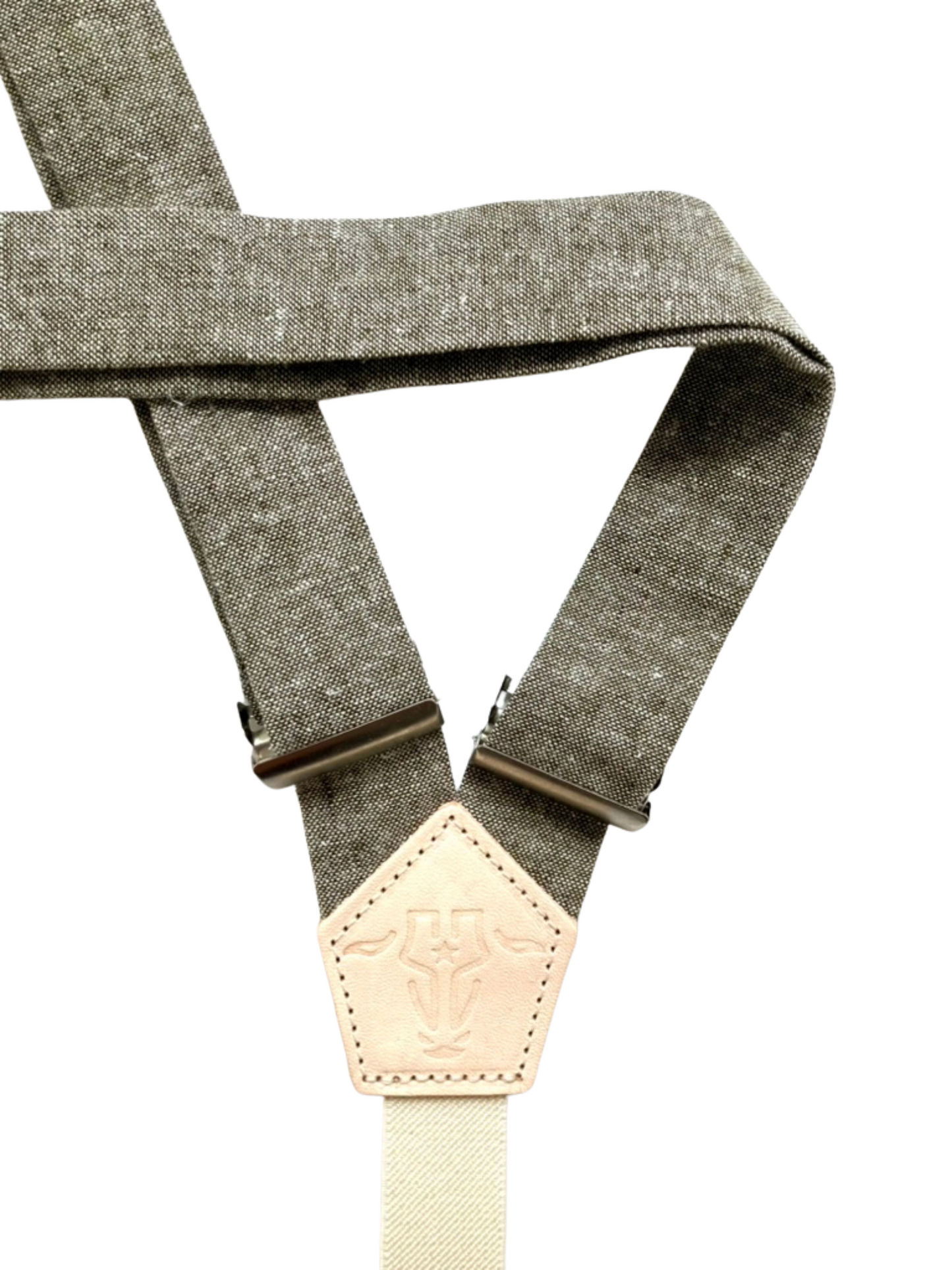Close-up of olive linen women’s suspenders with natural leather back patch, handmade in Texas.
