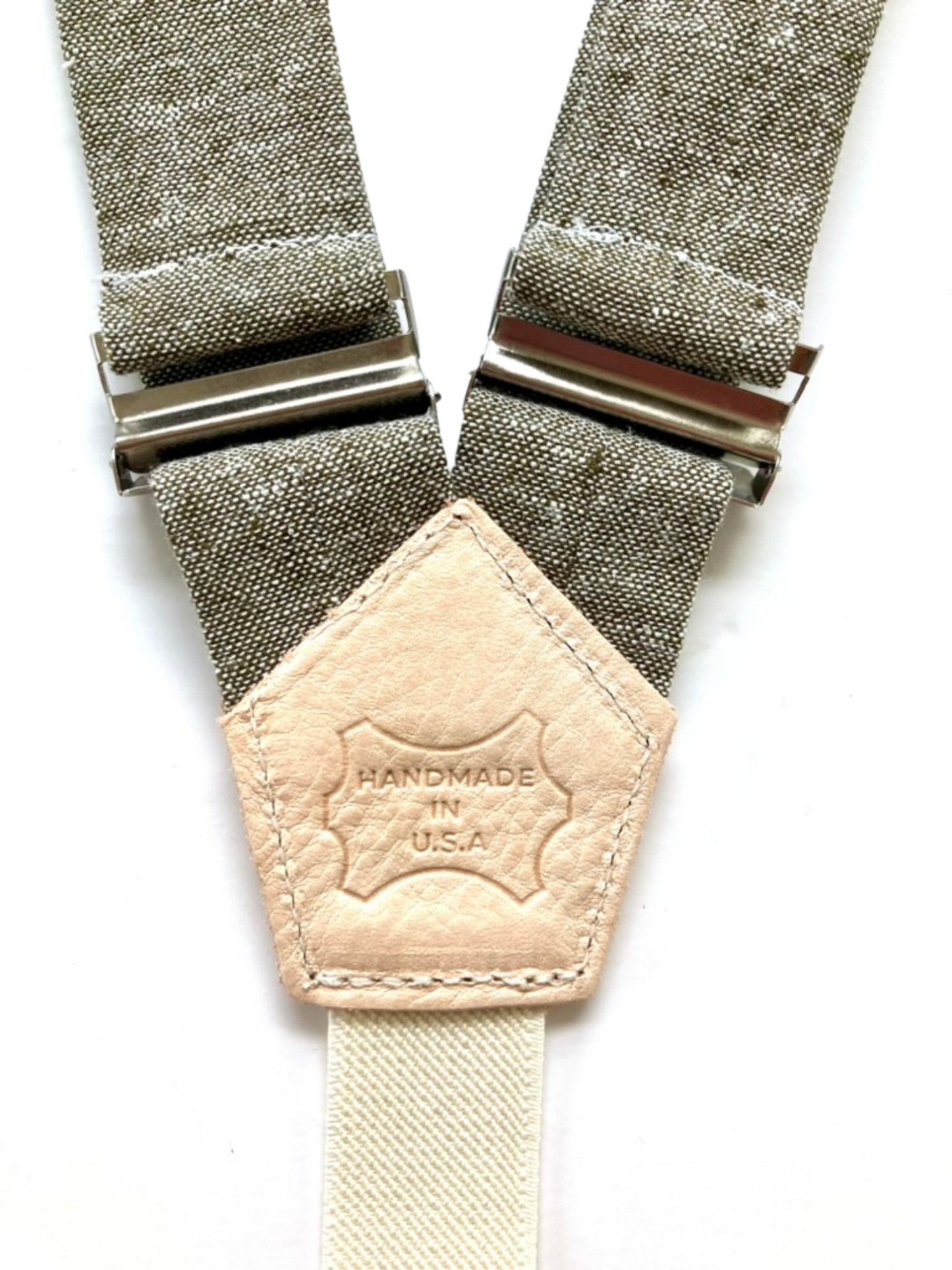 Olive linen women’s suspenders with natural leather back patch stamped Handmade in USA, vintage-inspired accessory.