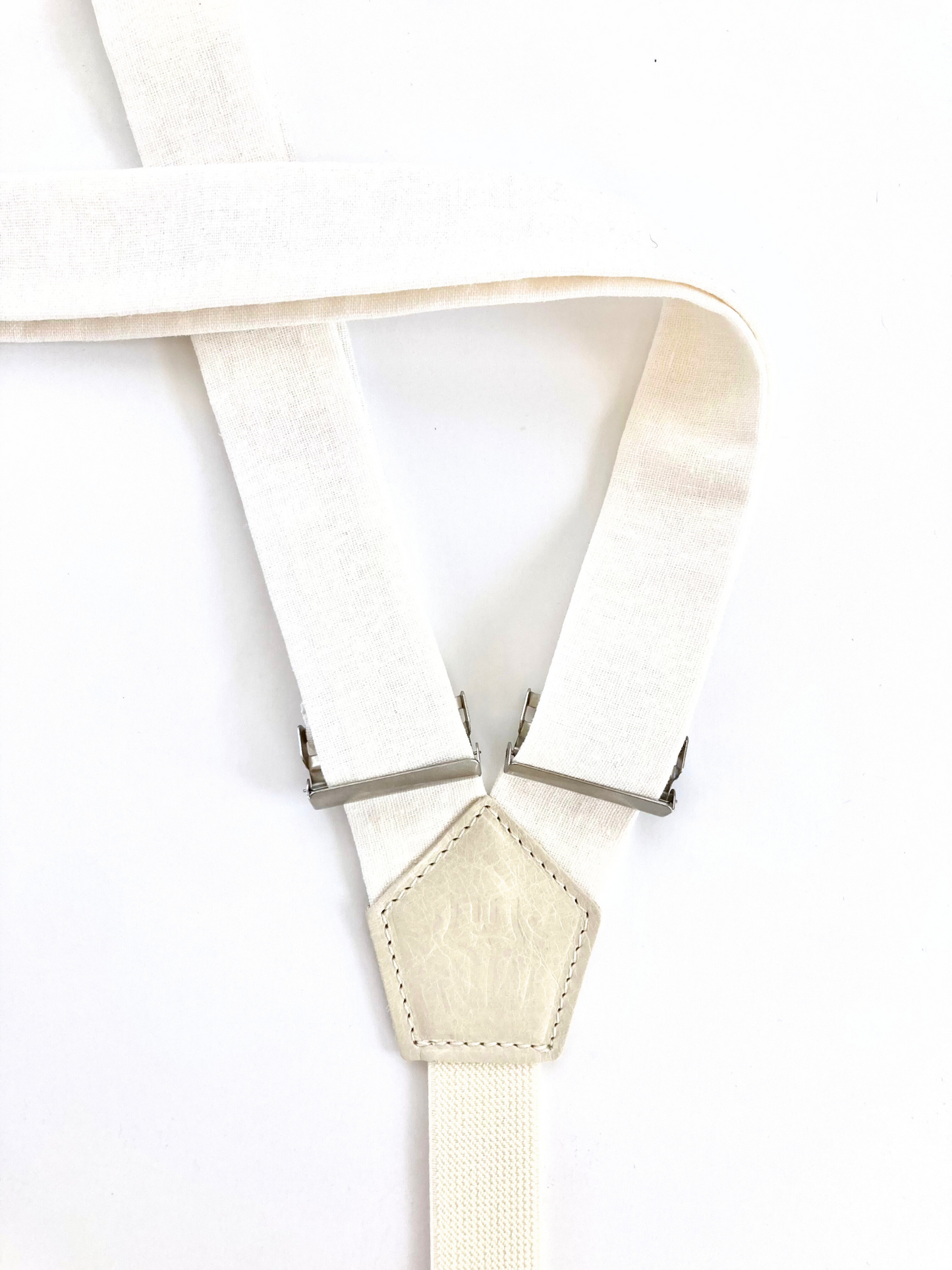 Detail of women’s white linen suspenders – handmade in Texas with premium fabric and silver adjusters