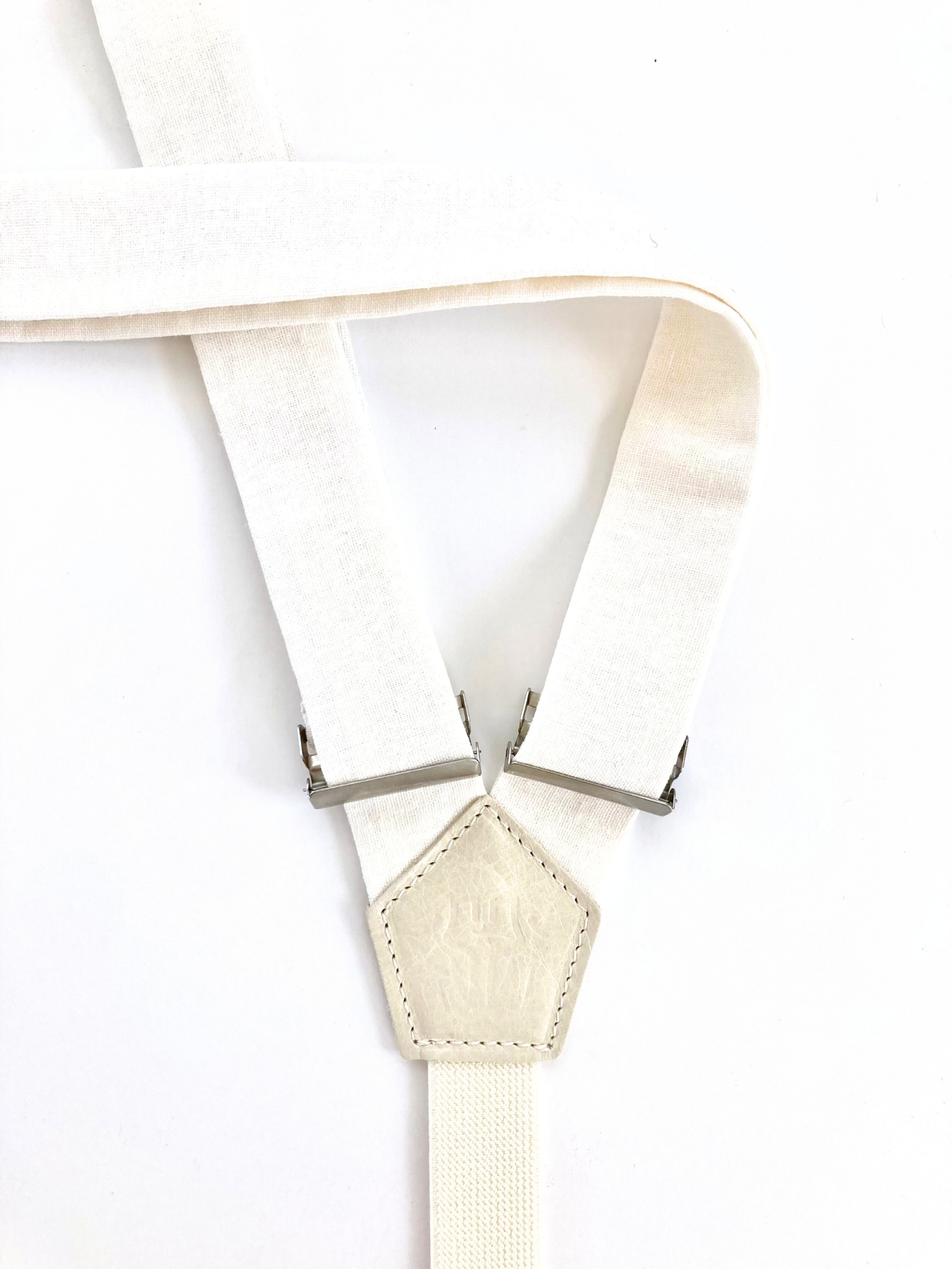 Detail of women’s white linen suspenders – handmade in Texas with premium fabric and silver adjusters