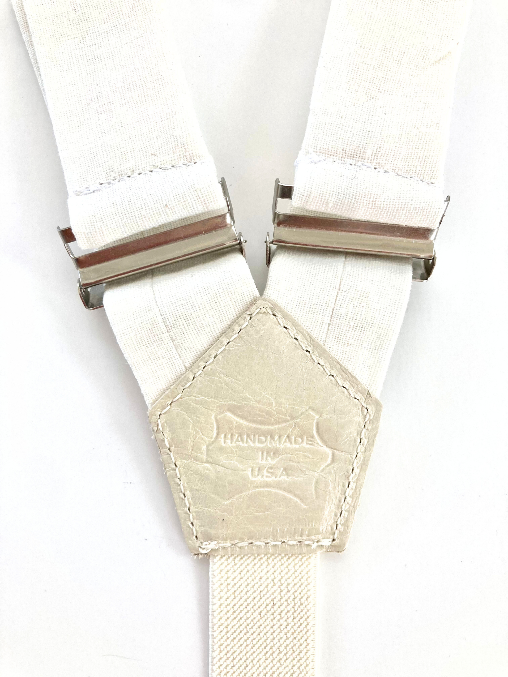 Women’s white linen suspenders with ivory leather back patch stamped Handmade in USA – artisan detail view