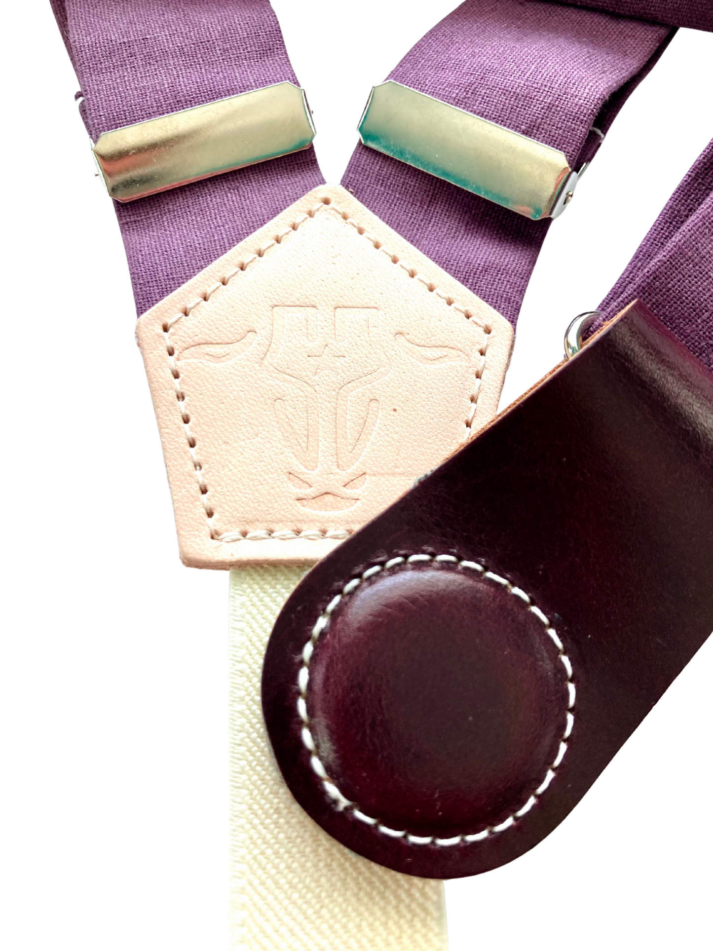 Close-up of plum linen women’s suspenders with special-edition wine leather magnetic clasp, handmade in Texas.