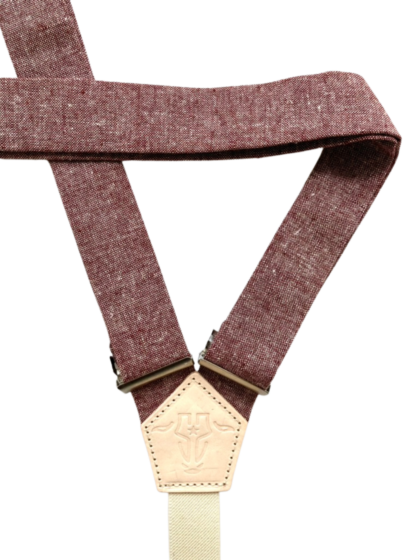 Back detail of rust maroon women’s linen suspenders with leather back patch, handmade in Texas.