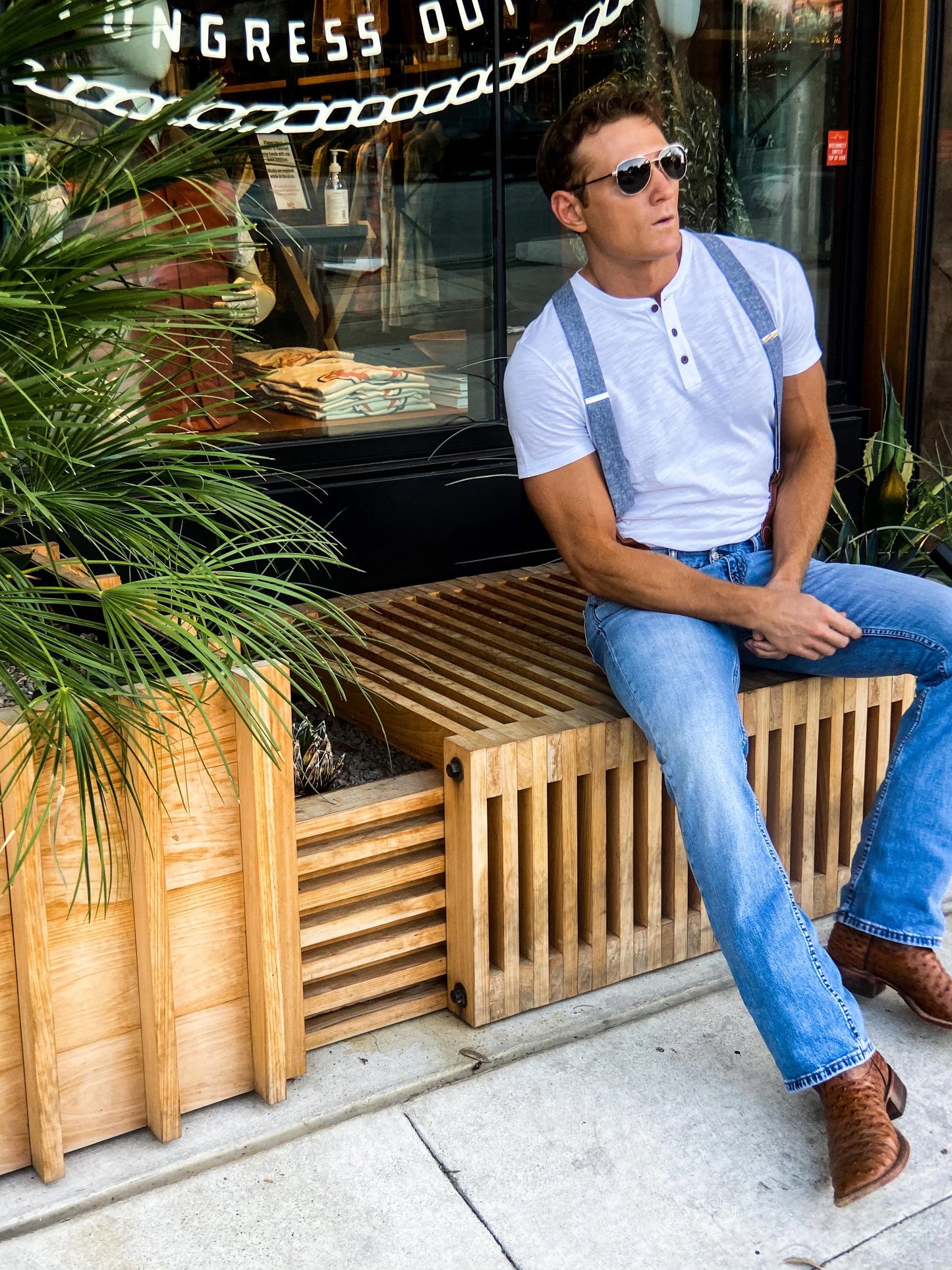 Handmade denim blue linen suspenders for men styled casually outside Tecovas on South Congress in Austin, Texas — perfect button-on braces for rustic weddings and modern western fashion.