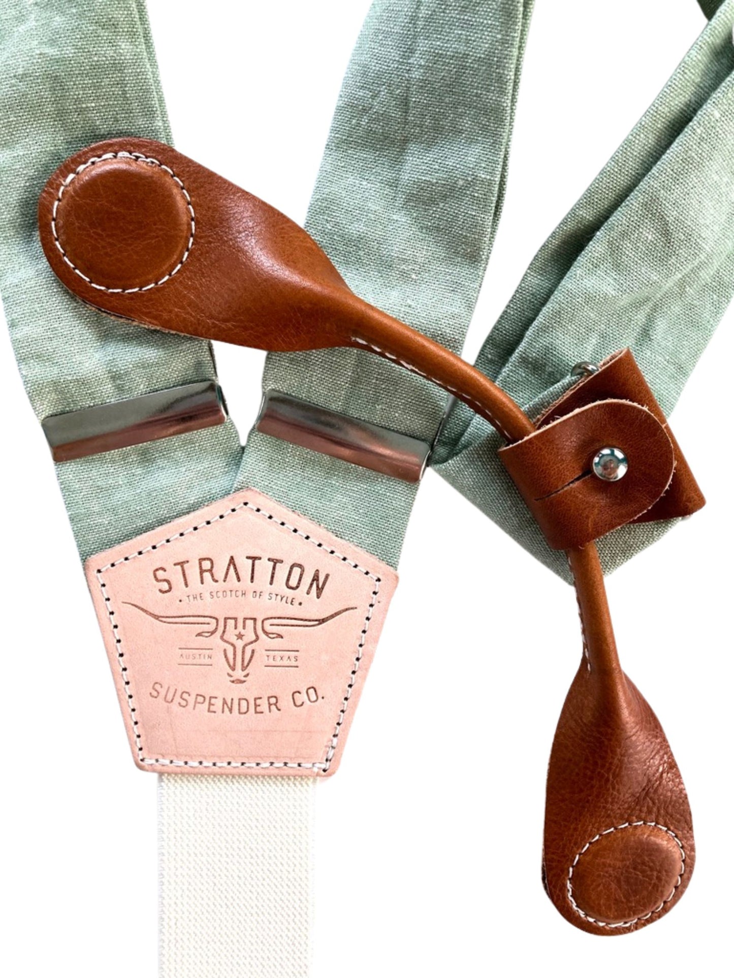 Tan leather magnetic clasp over pistachio green linen suspenders—perfect for groomsmen gifts and rustic wedding menswear.