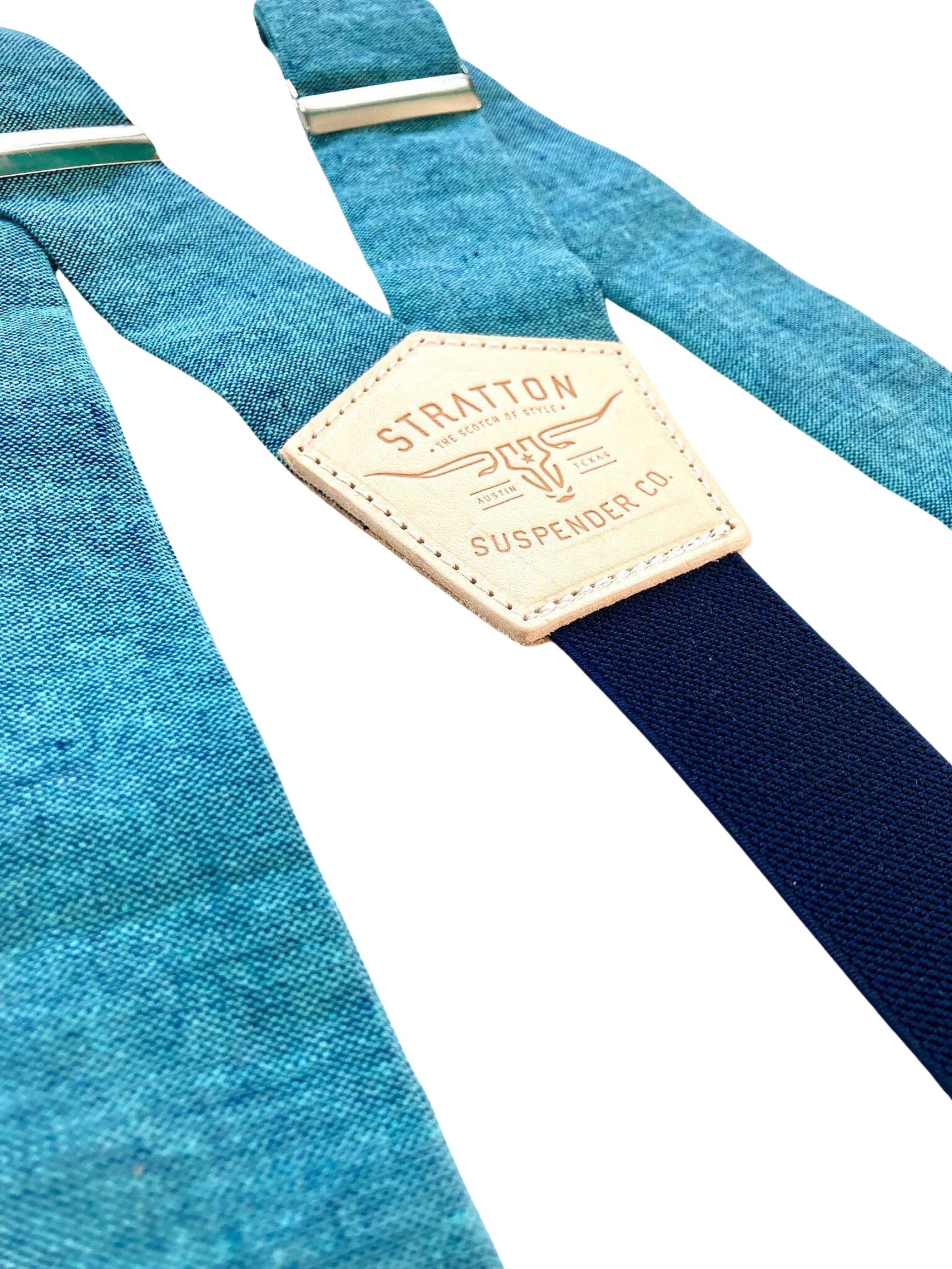 Close-up of turquoise blue Malibu linen wedding suspenders with a navy back strap and premium leather detailing. Handmade in USA – perfect for groomsmen, beach weddings, and vintage-inspired menswear.