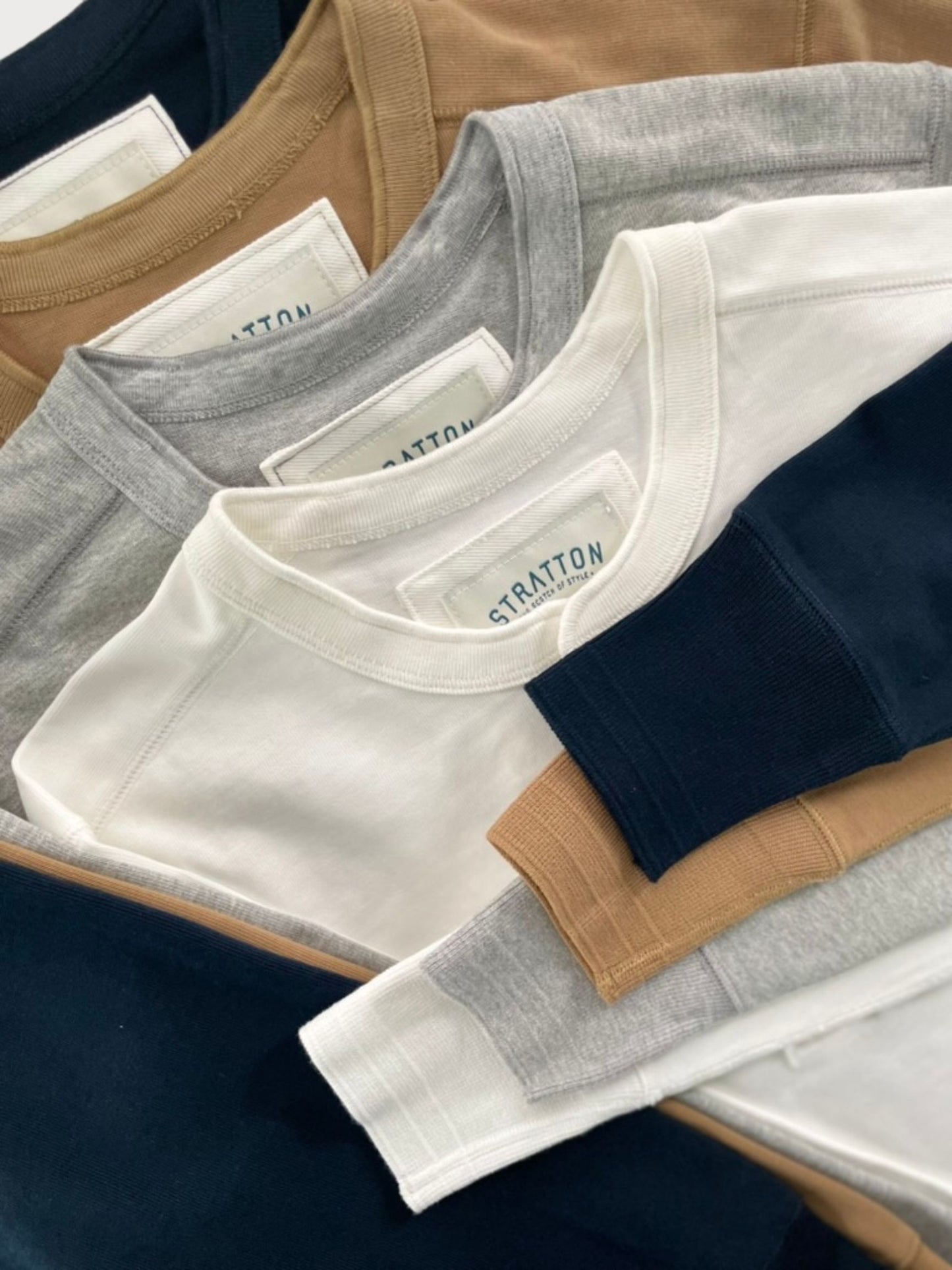 Stratton Suspender Co. Vintage 1940s Heavyweight Henley Collection in Tobacco Brown, Heather Gray, Vintage White, and Navy Blue. Made in the USA from premium heavyweight cotton, featuring ribbed cuffs and a three-button placket for classic heritage workwear style.