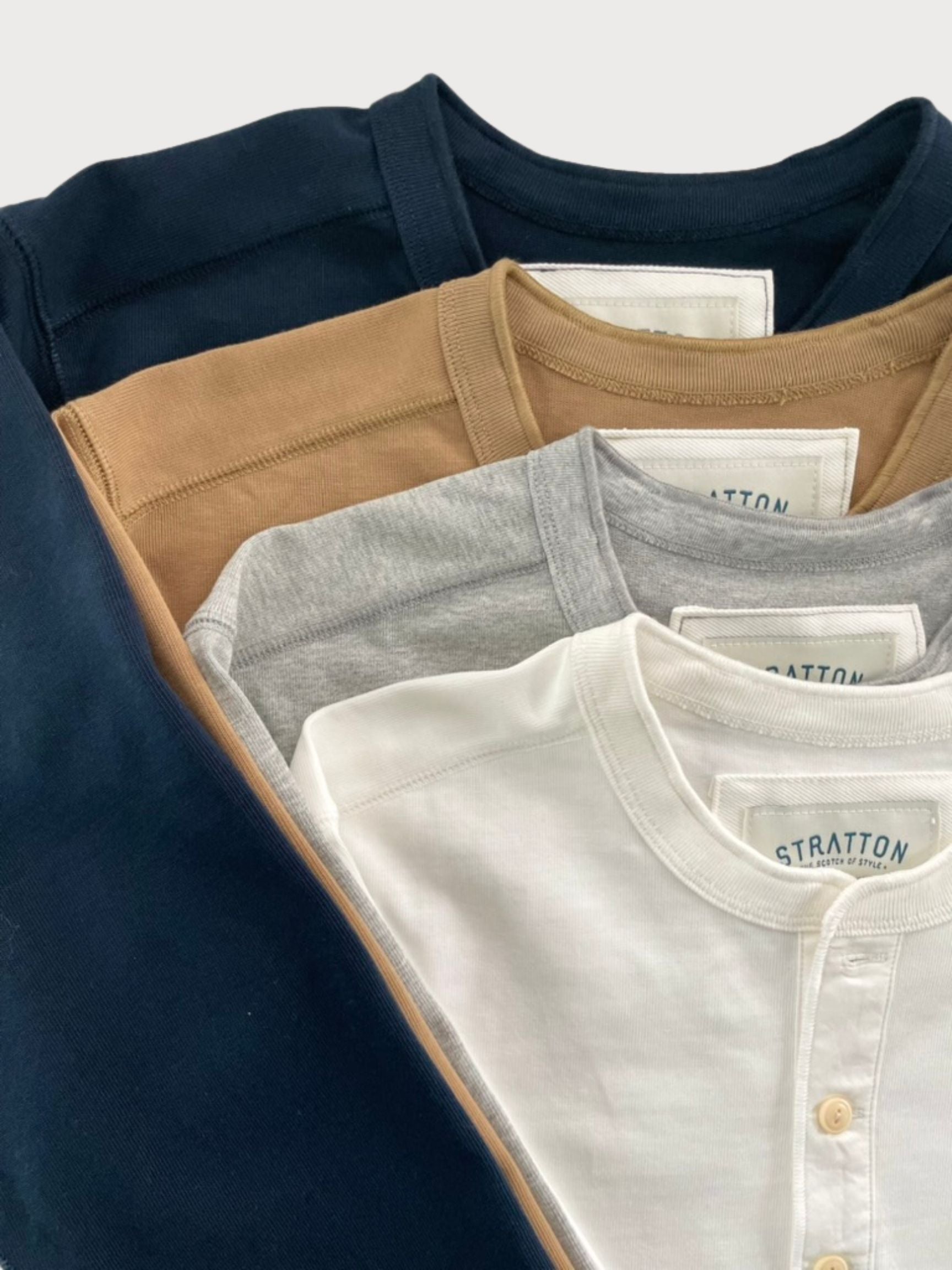 Stratton Suspender Co. Vintage 1940s Heavyweight Henley Shirts in Navy Blue, Tobacco Brown, Heather Gray, and Vintage White. Made in the USA with premium heavyweight cotton, featuring a three-button placket and ribbed cuffs for classic workwear styling.