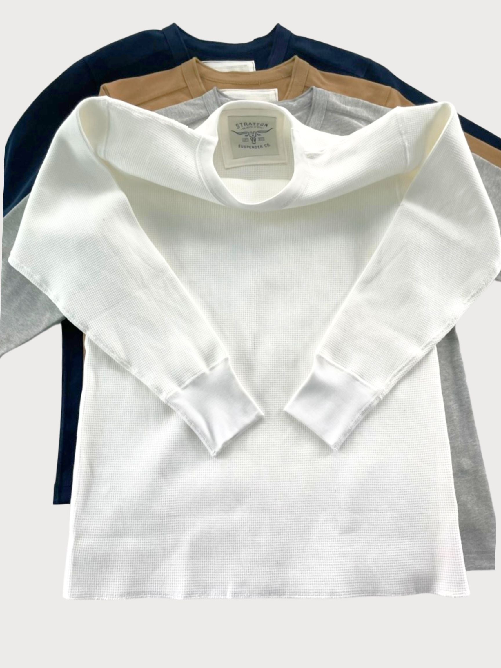 A collection of vintage-inspired heavyweight waffle knit thermal shirts in white, gray, tan, and navy, showcasing their durable construction and timeless workwear style. Ethically made in the USA, designed for warmth, layering, and classic American heritage. Stratton Suspender Co.