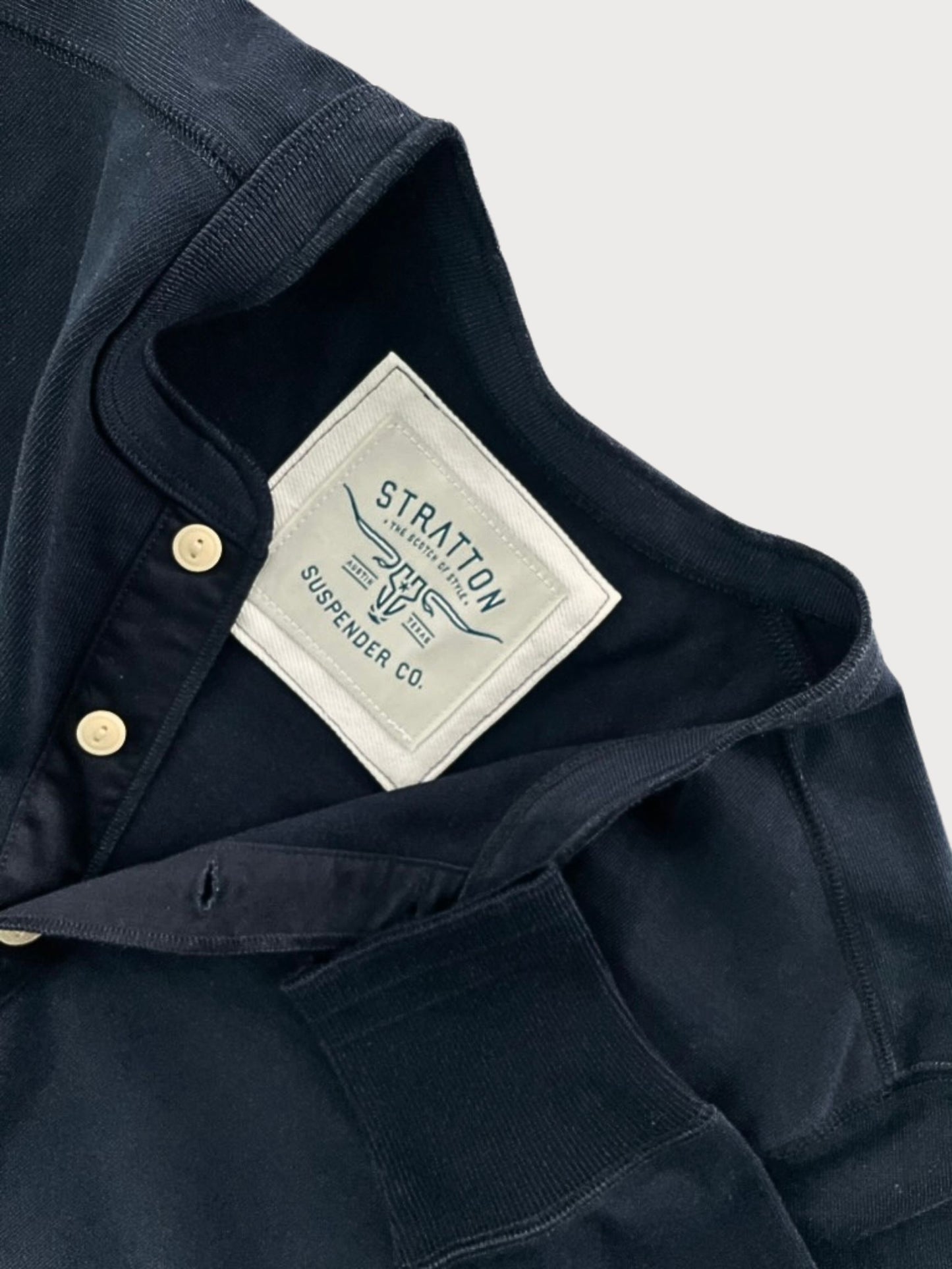 Close-up of Vintage 1940s Navy Heavyweight Henley by Stratton Suspender Co., highlighting the ribbed sleeve cuff, three-button placket, and embroidered brand label. Made in the USA from premium heavyweight cotton for durability and classic heritage workwear style.