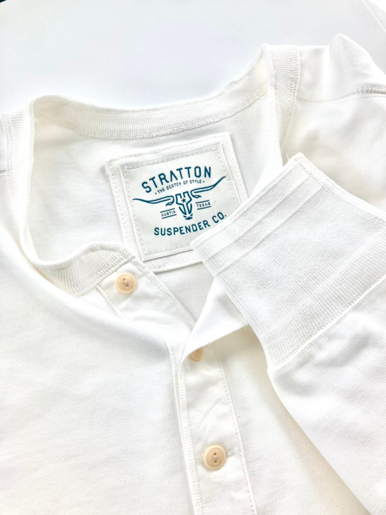 Close-up of Vintage 1940s Vintage White Heavyweight Henley by Stratton Suspender Co., highlighting ribbed sleeve cuff, three-button placket, and embroidered brand label. Made in the USA from premium heavyweight cotton for a timeless heritage workwear look.