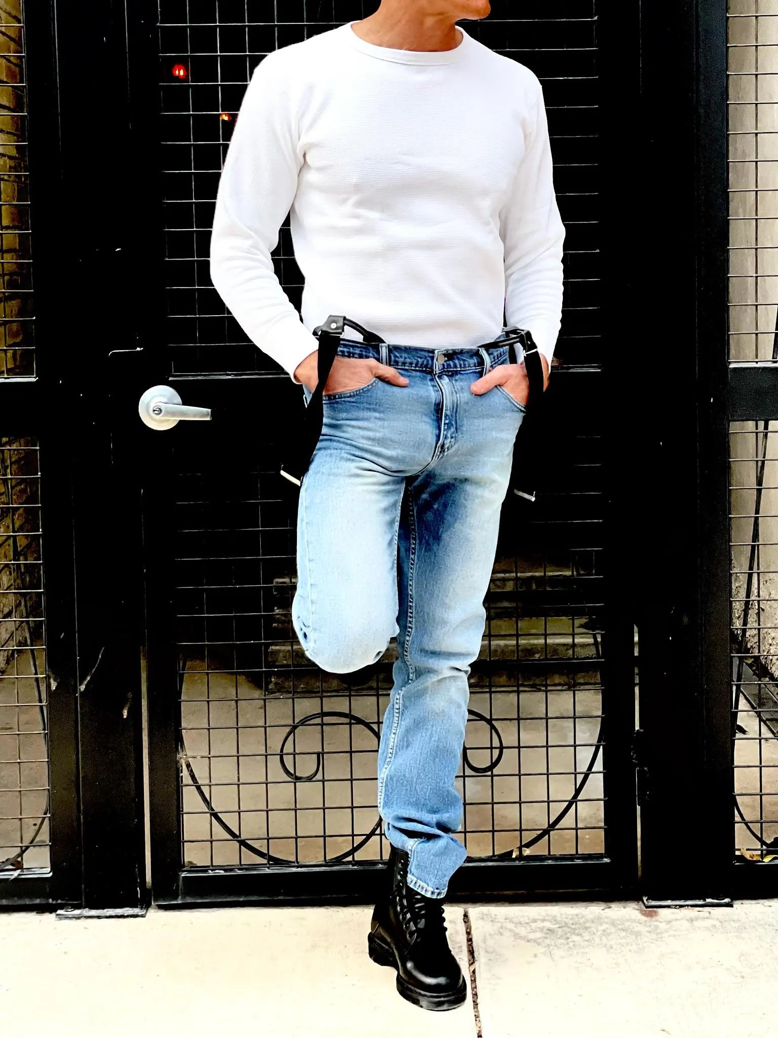 Vintage 1940s waffle knit thermal shirt in vintage white, styled with Vintage Levi’s, black suspenders, and Dr. Martens boots. This heavyweight long sleeve thermal is inspired by pre-war American workwear, offering warmth, durability, and classic style. Ethically made in the USA by Stratton Suspender Co.