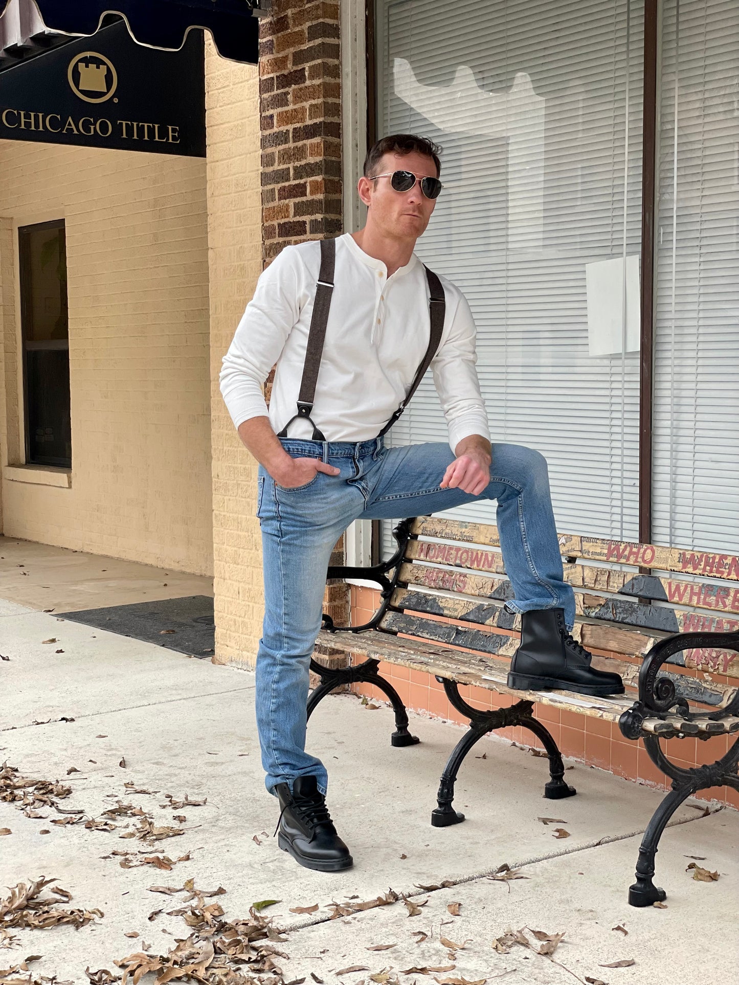 Man wearing a Vintage White Henley and brown wool suspenders by Stratton Suspender Co., paired with rugged denim and black boots. A timeless American workwear look, blending heritage craftsmanship with modern menswear style.