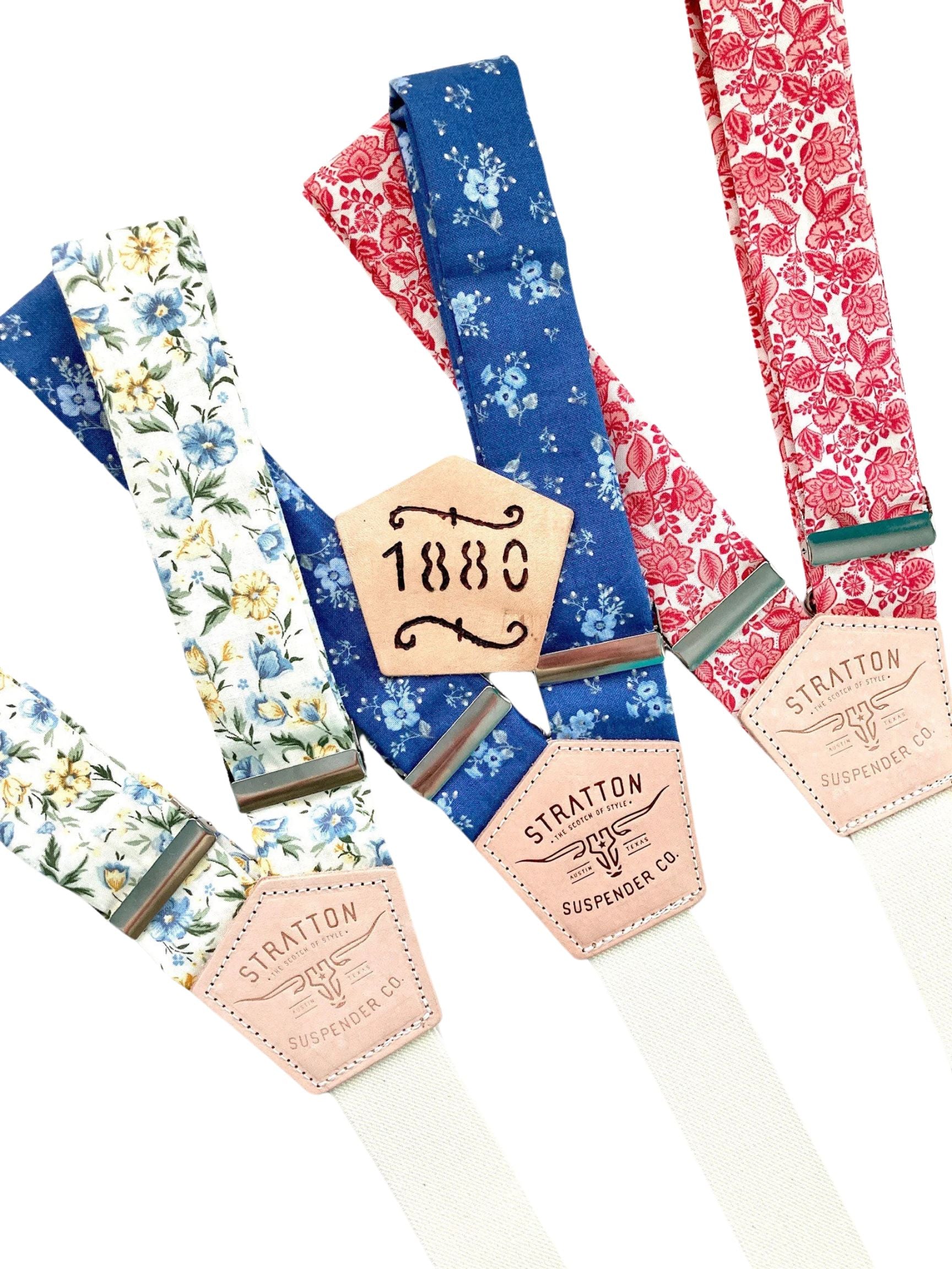 Vintage floral suspenders collection featuring cornflower blue, marigold, and red floral designs with Stratton Suspender Co. leather back patches.