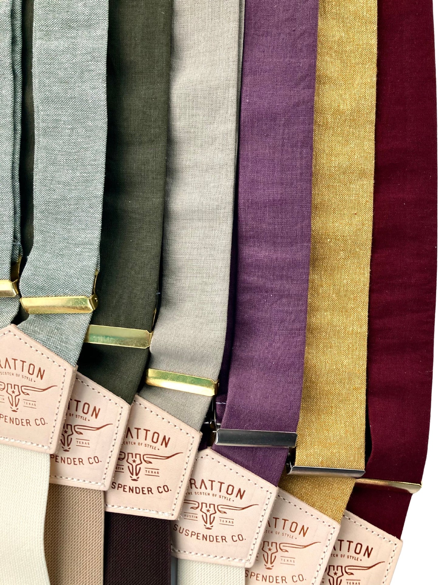 Collection of rustic linen wedding suspenders in coordinated colors including sage, moss, soft gray, lilac, marigold yellow, and deep burgundy.