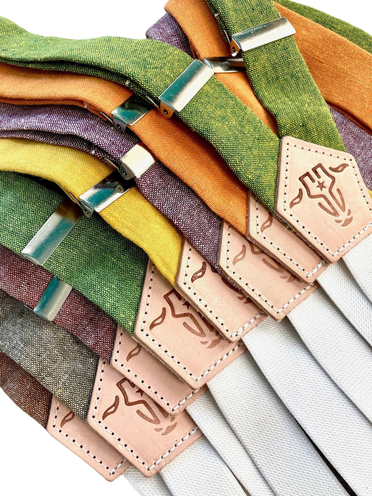 Women's Magnetic Clasp Suspender Straps by Stratton Suspender Co. in Fall Colors – Nutmeg, Moss Green, Rust, Chartreuse Green, Mustard Yellow, Purple, Tangerine Orange, and Kelly Green. Handmade in Texas for vintage-inspired style and modern convenience.