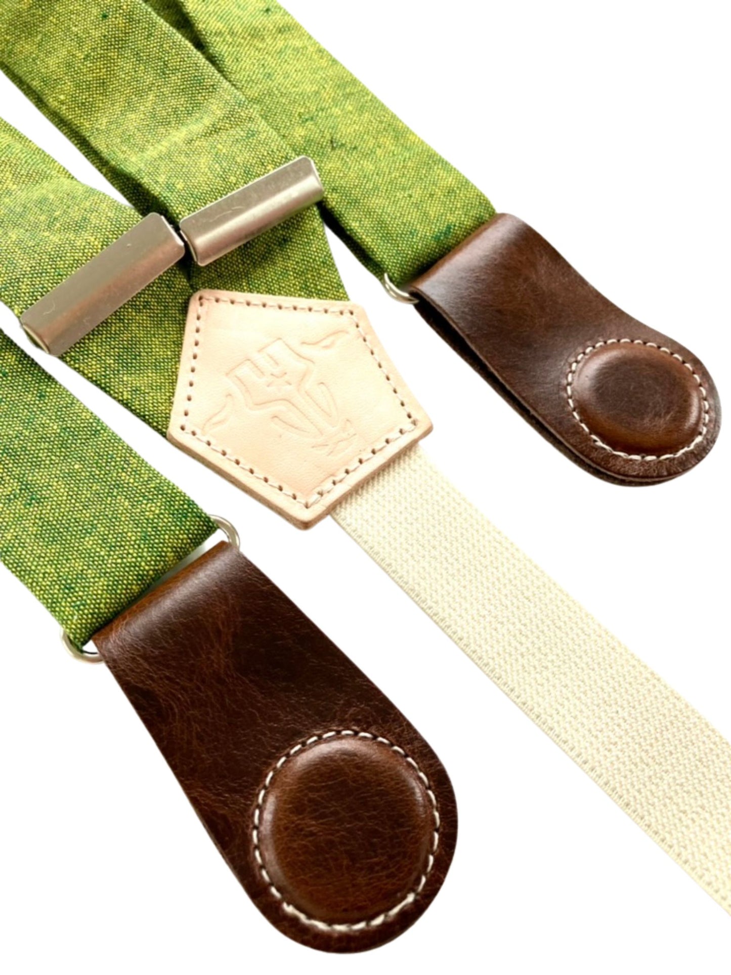 Close-up of women’s chartreuse green linen suspenders with dark brown leather magnetic clasps and cream backstrap.
