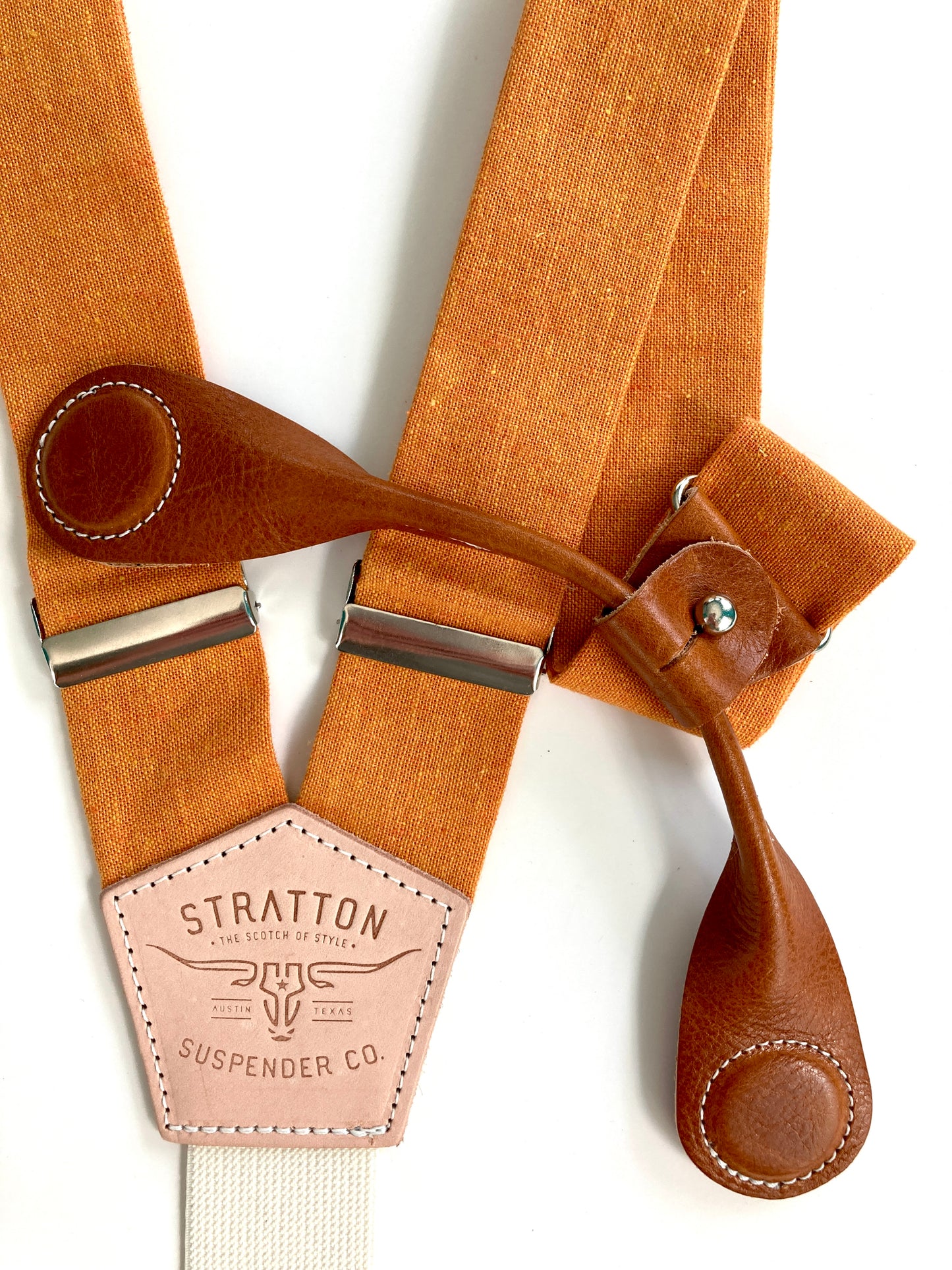 Stratton Suspender Co. features the orange linen suspenders on veg tan shoulder leather with cream colored elastic back strap for the Fall 2022 suspenders collection Magnetic Stratton Suspender clasps in Tan Pontedero Italian leather hand-picked by Stratton Suspender Co.