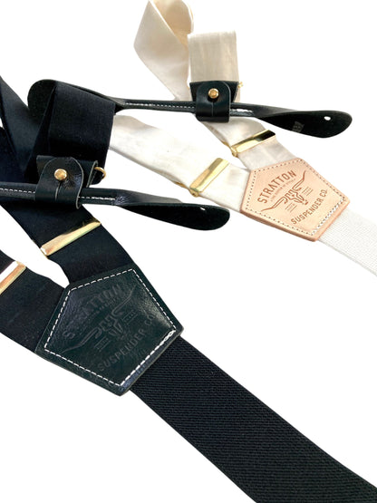 Handmade black and ivory linen button-on suspenders with full-grain veg-tan leather, gold-colored solid brass hardware, and soft twill elastic. Ethically made in Texas, perfect for weddings, formal wear, groomsmen, and heritage menswear. Timeless and refined style.