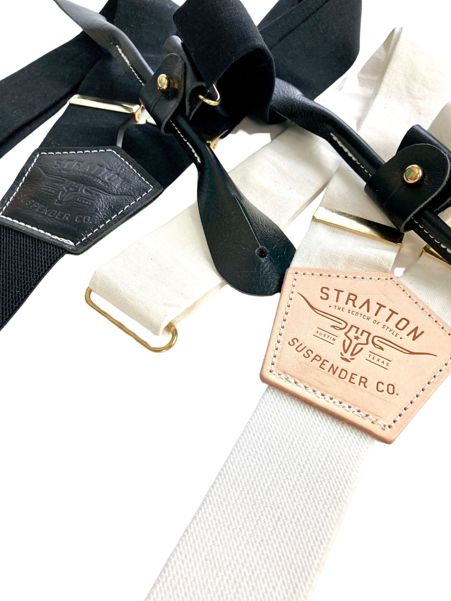 Handmade black and ivory linen button-on suspenders with full-grain veg-tan leather, gold-colored solid brass hardware, and premium soft twill elastic. Ethically made in Texas, perfect for formal wear, weddings, groomsmen, and heritage menswear. Timeless and refined.