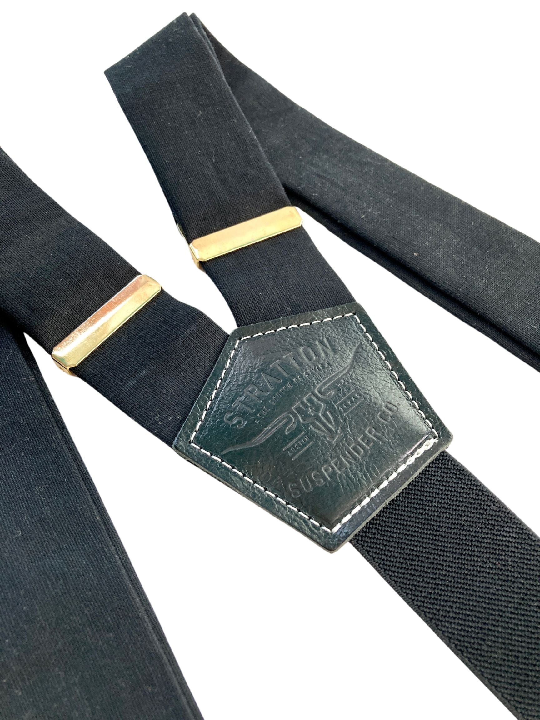 Handmade black linen button-on suspenders with full-grain veg-tan leather, gold-colored solid brass hardware, and premium soft twill elastic. Ethically made in Texas, perfect for formal wear, weddings, groomsmen, and heritage menswear. Timeless and refined.