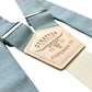 Dusty blue linen wedding button on suspenders for groom and groomsmen